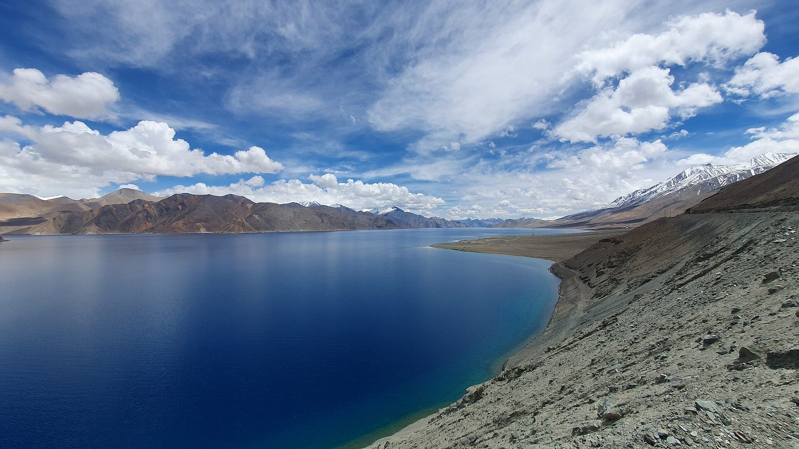 The deep blue water of Pangong Tso curving between bare Ladakhi mountains